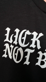 close up detail on the print “lick pussy not boots” hand printed 
