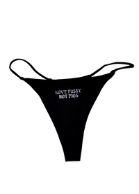 Black string thong with "Love Pussy Not Pigs" printed small in white gothic letters on the front
