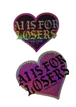 Two heart-shaped AI Is for Losers anti AI stickers, one pink holographic glitter and one black glitter, with black gothic lettering