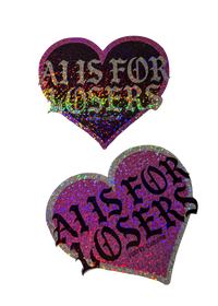 Two heart-shaped AI Is for Losers anti AI stickers, one pink holographic glitter and one black glitter, with black gothic lettering