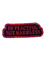 pink glitter be peaceful not harmless sticker