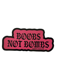 Pink Boobs Not Bombs sticker with black gothic lettering and a black border