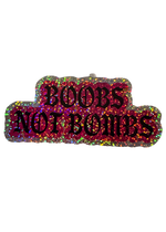 Pink and silver glitter Boobs Not Bombs sticker with black gothic lettering