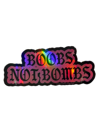 Pink holographic Boobs Not Bombs sticker with black gothic lettering