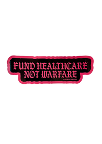 Black Fund Healthcare Not Warfare sticker with pink gothic lettering and a pink edge