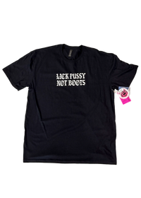 Black t-shirt laid flat with "Lick Pussy Not Boots" in small white gothic letters on the chest and a pink hangtag pinned to the sleeve