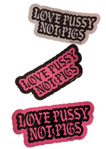 Three Love Pussy Not Pigs anti police stickers in white, black and pink, each with gothic lettering