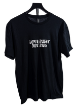 Love Pussy Not Pigs anti police t-shirt on a hanger, black with a white gothic chest print