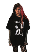 alternative femme with piercings, tattoos and split dye hair wearing a boxy oversized "ruin rapists' lives" tee 