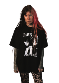 alternative femme with piercings, tattoos and split dye hair wearing a boxy oversized "ruin rapists' lives" tee 