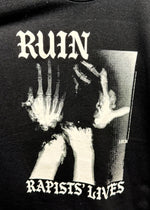 Close-up of the Ruin Rapists' Lives print: a grainy black and white photo of a figure with hands raised to their face between gothic lettering
